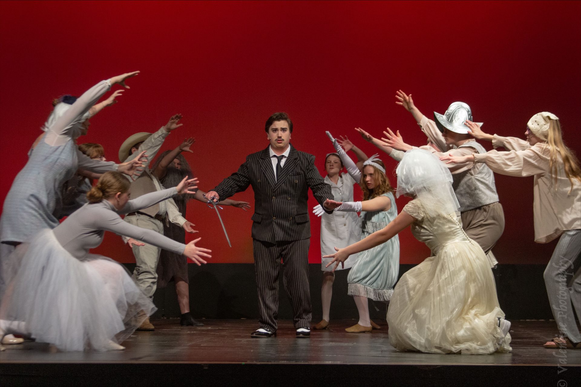 Man standing in center with people crowding him
